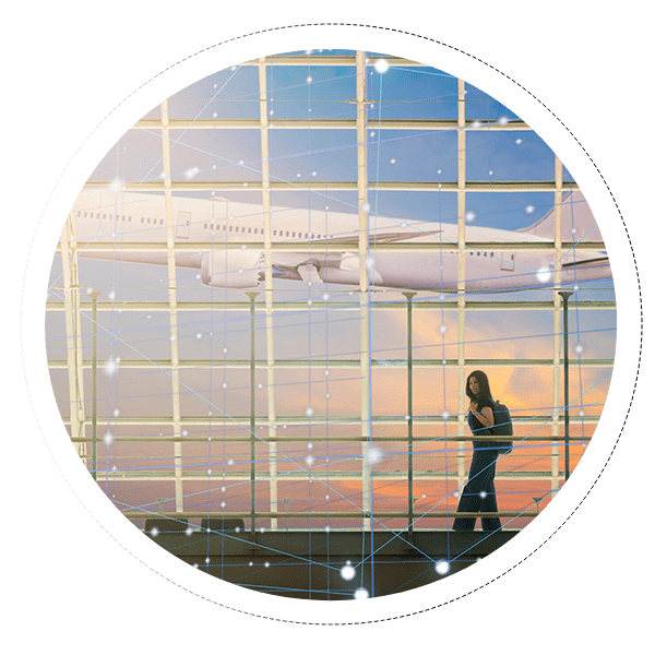 A person standing in front of an airport window.