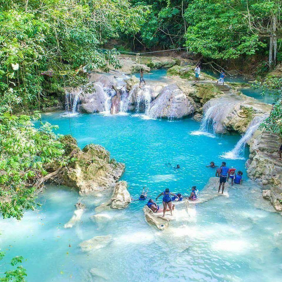 A group of people standing around in the water.