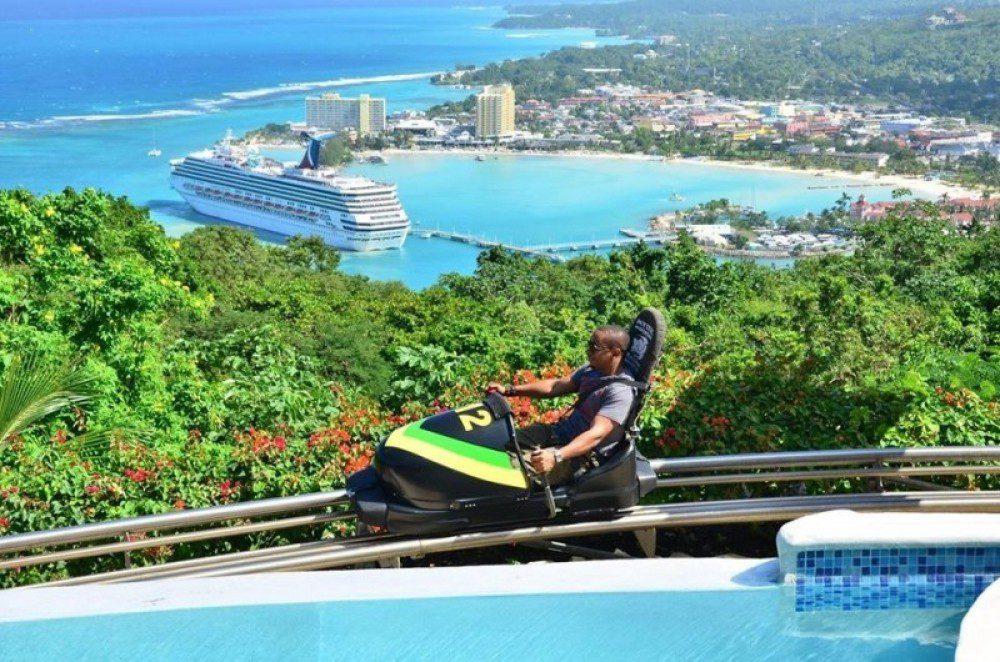 A man riding a go kart on top of a hill.