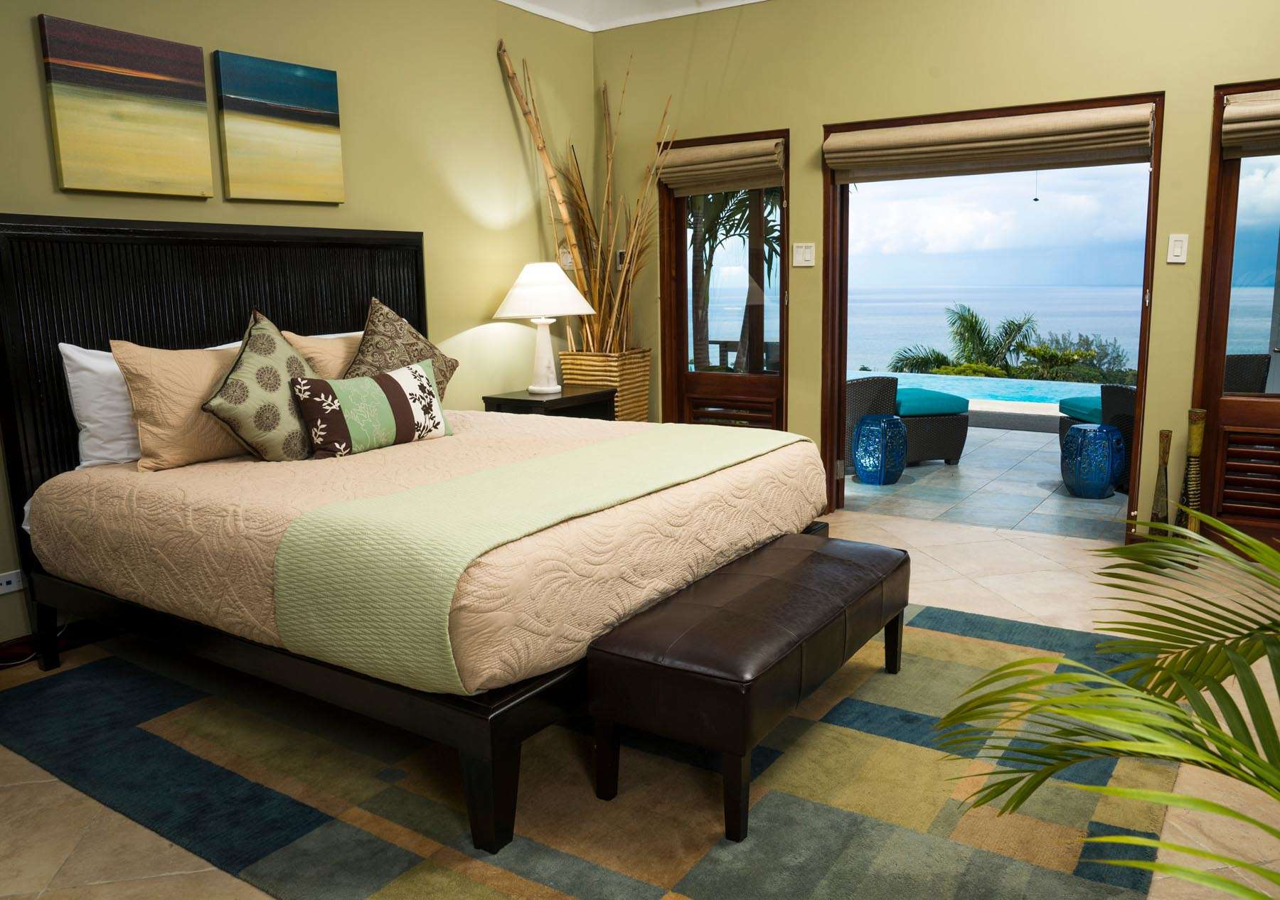 A bedroom with a view of the ocean and a bed.