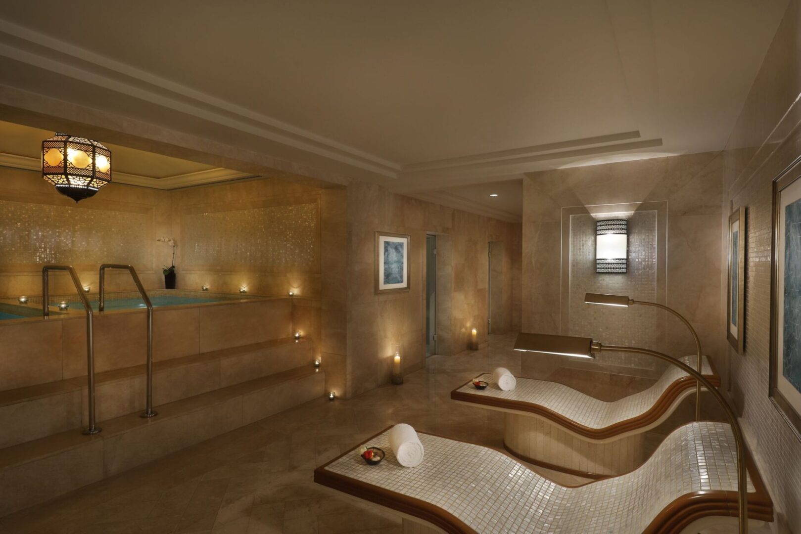 A spa room with two beds and a large tub