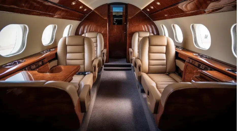 A small airplane with tan leather seats and brown wood trim.